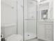 Bathroom features a modern glass enclosed shower, white cabinets, and stone countertops at 3562 Sunderland Ne Cir, Atlanta, GA 30319