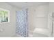 Bright bathroom with a tiled shower, and a blue patterned shower curtain at 3562 Sunderland Ne Cir, Atlanta, GA 30319