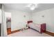 Cozy bedroom features a white rocking chair, warm wood floors and a red bed frame at 3562 Sunderland Ne Cir, Atlanta, GA 30319