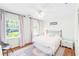 Comfortable bedroom with hardwood floors, two windows, and a ceiling fan at 3562 Sunderland Ne Cir, Atlanta, GA 30319