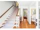 Bright foyer showcasing hardwood floors and a carpeted staircase leading to the upper level at 3562 Sunderland Ne Cir, Atlanta, GA 30319