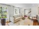 Sunlit living room with large windows, hardwood floors, and a cozy seating area at 3562 Sunderland Ne Cir, Atlanta, GA 30319