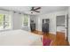 Spacious main bedroom with hardwood floors, two windows, and a ceiling fan at 3562 Sunderland Ne Cir, Atlanta, GA 30319