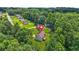 An aerial view of the residence nestled among mature trees in a quiet, established neighborhood at 3927 Villager Way, Rex, GA 30273