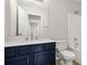 Bathroom with a blue vanity, white counter, toilet, shower and mirror at 3927 Villager Way, Rex, GA 30273