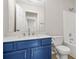 Stylish bathroom features blue vanity, white countertop, a large mirror, and combination tub shower at 3927 Villager Way, Rex, GA 30273