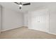 Cozy bedroom with plush carpeting, a ceiling fan, and a double closet providing ample storage space at 3927 Villager Way, Rex, GA 30273