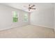 Spacious bedroom featuring neutral carpet, two windows and overhead fan at 3927 Villager Way, Rex, GA 30273