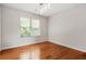 Neutral bedroom with hardwood floors, a window with blinds, and ample natural light at 3927 Villager Way, Rex, GA 30273