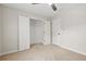 Neutral bedroom boasts plush carpet, a ceiling fan, and a walk-in closet at 3927 Villager Way, Rex, GA 30273