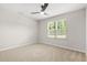 A neutral bedroom features a ceiling fan and a window that lets in natural light at 3927 Villager Way, Rex, GA 30273