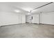 This clean garage features white walls, grey floors, and two doors at 3927 Villager Way, Rex, GA 30273