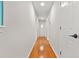 Hallway features beautiful hardwood floors, neutral paint, and white doors at 3927 Villager Way, Rex, GA 30273