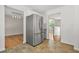Spacious kitchen featuring stainless steel refrigerator, tile floor, wood accents and entrance to dining room at 3927 Villager Way, Rex, GA 30273