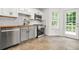 Updated kitchen with white cabinets, stainless steel appliances, wooden countertops and tile flooring at 3927 Villager Way, Rex, GA 30273