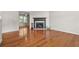 Bright living room featuring hardwood floors and a cozy fireplace with black trim and decorative metal accents at 3927 Villager Way, Rex, GA 30273