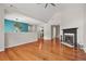 Open living room showcasing a fireplace, hardwood floors, and modern lighting at 3927 Villager Way, Rex, GA 30273