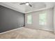 Bright main bedroom features a ceiling fan, tray ceiling and two windows at 3927 Villager Way, Rex, GA 30273