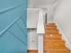 Lovely staircase with hardwood floors and a bright blue accent wall at 3927 Villager Way, Rex, GA 30273
