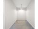Narrow storage room featuring painted concrete floors, white walls, and one overhead light at 3927 Villager Way, Rex, GA 30273