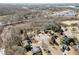 Aerial view of homes nestled near a picturesque river and tranquil wooded area, ideal setting at 7430 Valley Landing Ct, Cumming, GA 30041