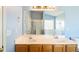 Bright bathroom features a double sink vanity, modern fixtures, and a large mirror at 7430 Valley Landing Ct, Cumming, GA 30041