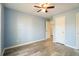 Bedroom with a ceiling fan, light blue walls, and luxury vinyl plank flooring at 7430 Valley Landing Ct, Cumming, GA 30041