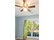 Bedroom with large windows, ceiling fan, and views of mature trees at 7430 Valley Landing Ct, Cumming, GA 30041