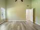 Bright bedroom featuring high ceilings, natural light, and modern vinyl flooring at 7430 Valley Landing Ct, Cumming, GA 30041