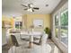 Bright dining area with a modern table set, large windows, and natural light at 7430 Valley Landing Ct, Cumming, GA 30041