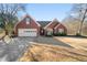 Charming brick home featuring a two-car garage and well-maintained front yard at 7430 Valley Landing Ct, Cumming, GA 30041