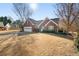 Lovely brick home with a well-kept lawn, side-entry garage and manicured landscaping at 7430 Valley Landing Ct, Cumming, GA 30041