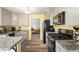 Well-lit kitchen featuring granite countertops, stainless steel appliances, and updated cabinetry at 7430 Valley Landing Ct, Cumming, GA 30041