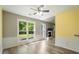 Spacious living area with large windows, a fireplace, and modern flooring at 7430 Valley Landing Ct, Cumming, GA 30041