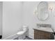 Elegant half bathroom with a marble countertop, decorative mirror, and stylish sconces at 819 Loridans Ne Dr, Atlanta, GA 30342