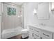 Bright bathroom featuring a shower over tub and white vanity with modern fixtures and subway tile at 819 Loridans Ne Dr, Atlanta, GA 30342