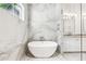 View of the soaking tub in the bathroom, with marble tiling and mosaic flooring at 819 Loridans Ne Dr, Atlanta, GA 30342