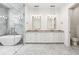 Bright bathroom with double vanity, a standalone tub, and a glass enclosed shower at 819 Loridans Ne Dr, Atlanta, GA 30342
