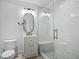 A modern bathroom featuring a glass enclosed shower with marble tile and a vanity with a dark framed mirror at 819 Loridans Ne Dr, Atlanta, GA 30342
