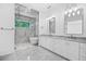 Bright bathroom featuring double vanity, glass enclosed shower, and a standalone tub at 819 Loridans Ne Dr, Atlanta, GA 30342