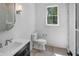 A bright bathroom features modern finishes and a glass shower, toilet, and vanity with sink at 819 Loridans Ne Dr, Atlanta, GA 30342