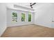 Bright bedroom with hardwood flooring, tray ceiling, ceiling fan, and an abundance of natural light at 819 Loridans Ne Dr, Atlanta, GA 30342