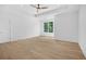 Large bedroom with hardwood flooring, tray ceiling, recessed lights, and large windows with natural light at 819 Loridans Ne Dr, Atlanta, GA 30342