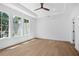 Spacious bedroom with tray ceiling, ceiling fan, hardwood flooring, and an abundance of natural light at 819 Loridans Ne Dr, Atlanta, GA 30342