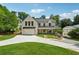 Stunning two-story home featuring a brick exterior, covered porch, and meticulously landscaped front yard at 819 Loridans Ne Dr, Atlanta, GA 30342