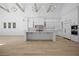 Well-lit kitchen area boasts a large center island, modern cabinetry, stone countertops and backsplash, and hardwood floors at 819 Loridans Ne Dr, Atlanta, GA 30342
