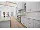 Chef's kitchen with stone countertops and backsplash, high end appliances and a large center island at 819 Loridans Ne Dr, Atlanta, GA 30342