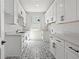 Well-lit laundry room with stylish patterned floor, ample cabinet storage, and quartz countertop at 819 Loridans Ne Dr, Atlanta, GA 30342