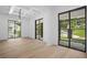 Spacious living room with hardwood floors, black-framed windows, and abundant natural light at 819 Loridans Ne Dr, Atlanta, GA 30342