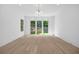 A bright living room with hardwood floors, recessed lighting, and large windows overlooking the backyard at 819 Loridans Ne Dr, Atlanta, GA 30342